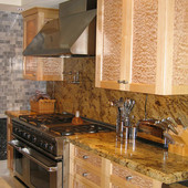 Kitchen, built-in: granite, natural maple and quilted maple.