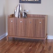 Console, freestanding: natural zebra wood with high gloss, hand rubbed finish.